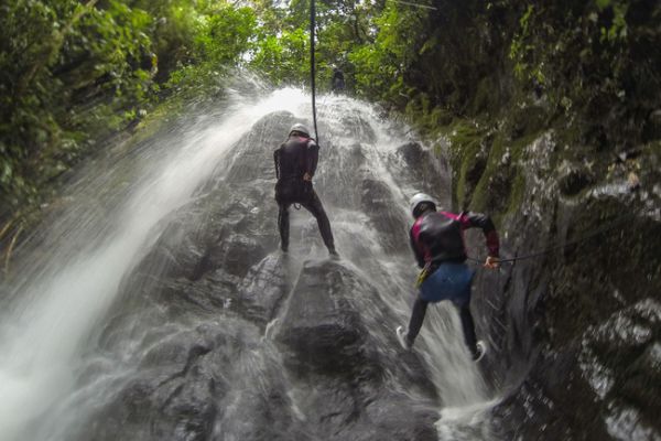 Canyoning in Río Blanco bij Baños, waarbij je langs watervallen en rotsen afdaalt midden in het tropische Andeslandschap.