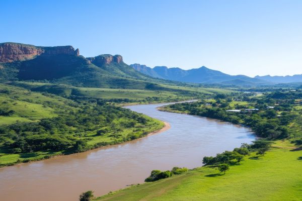Bela-Bela Waterberg river flowing through green hills under clear blue sky scenic landscape Southp-Africa