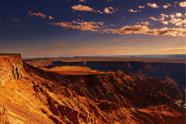 “Uitzicht over de Fish River Canyon in Namibië, met diepe kloven en uitgestrekt rotslandschap.”